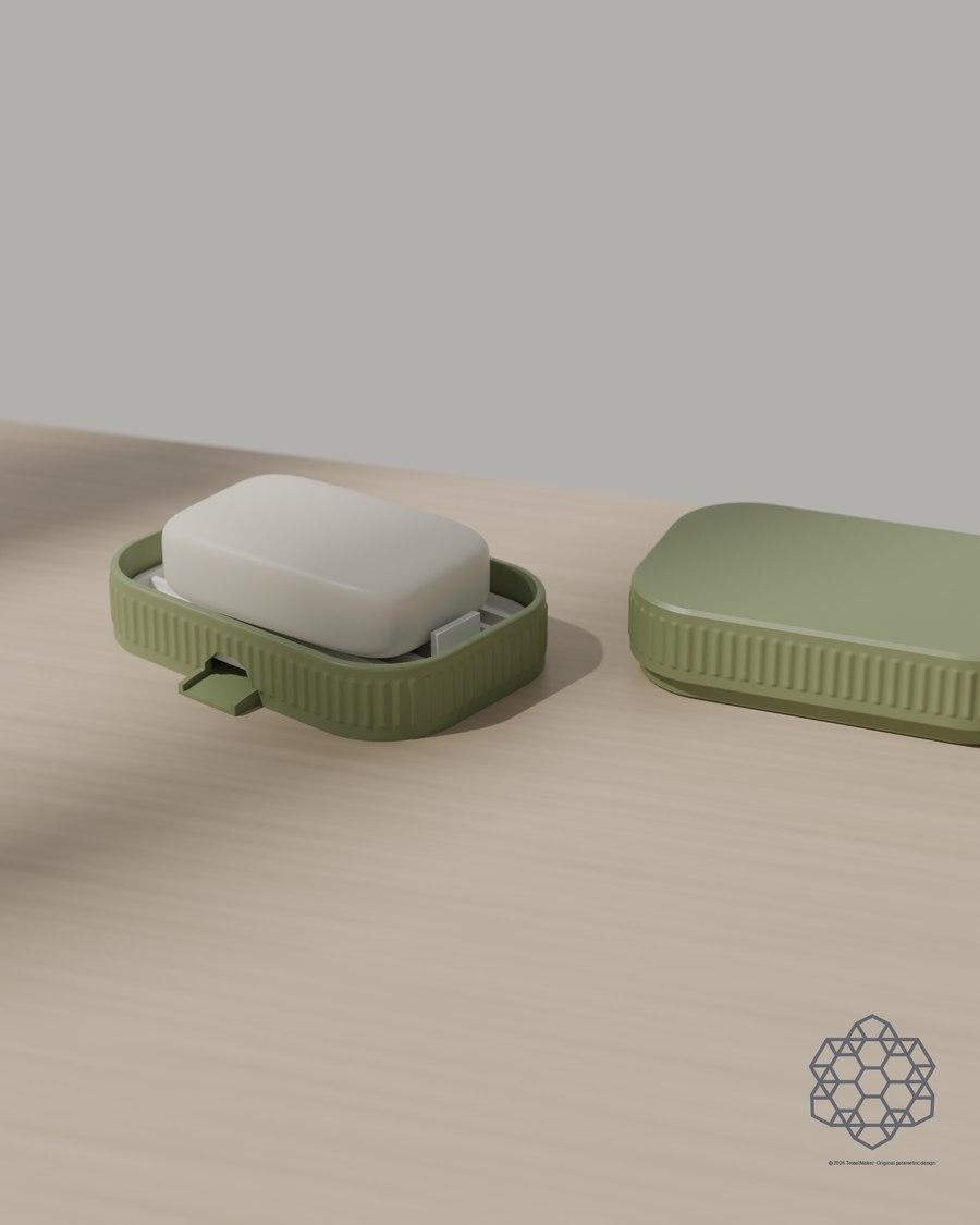 Covered soap dish in matcha green with a bar of soap on its white drain tray, the fluted lid resting alongside on a sunlit wooden table.