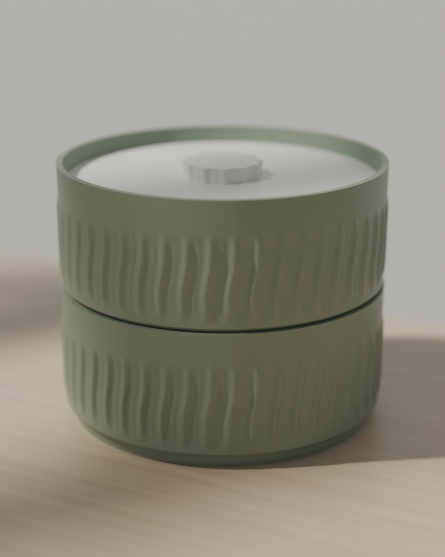 Two stacked sage storage bowls with ridged sides and a drop-in lid, on a sunlit wooden table.